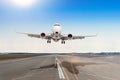 Passenger aircraft with a cast shadow on the asphalt landing on a runway airport. Royalty Free Stock Photo