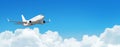 Passenger aircraft cloudscape with white airplane is flying in the daytime sky cumulus clouds, panorama view. Royalty Free Stock Photo