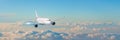 Passenger aircraft cloudscape with white airplane is flying in the evening sky cumulus clouds, panorama view. Royalty Free Stock Photo