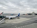 Milan, Italy - 17 august 2023: Passenger aircraft with a covered airstairs stands at the airfield Royalty Free Stock Photo