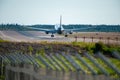 Passenger aircraft landing on the airport during daytime Royalty Free Stock Photo