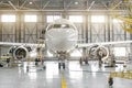 Passenger aircraft on maintenance of engine-disassembled engine blades and fuselage repair in airport hangar.