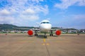 Passenger aircraft parked at the airport with covered red covers engines Royalty Free Stock Photo