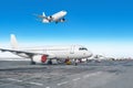 Passenger aircraft row, airplane parked on service before departure at the airport. One landing to runway in the blue sky. Royalty Free Stock Photo