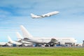 Passenger aircraft row, airplane parked on service before departure at the airport, other plane push back tow. One two-story airpl Royalty Free Stock Photo