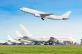 Passenger aircraft row, airplane parked on service before departure at the airport, other plane push back tow. One two-story airpl Royalty Free Stock Photo