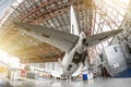 Passenger aircraft on service in an aviation hangar rear view of the tail, on the auxiliary power unit. Royalty Free Stock Photo