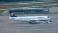 Passenger aircraft is towed by an aircraft tractor to its take-off position on the tarmac