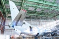 Passenger aircraft under maintenance in the hangar. Checking mechanical systems for flight operations. Close-up view of the tail