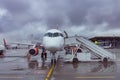 Passenger aircraft, waiting for the passengers to board at the airport terminal Royalty Free Stock Photo