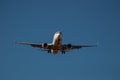 Passenger airline twin jet engine aircraft coming into land in blue sky