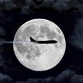 An passenger airliner airplane flies in front of a full moon Royalty Free Stock Photo