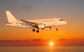 Passenger Airliner Landing Over The Sea During Sunset, Side View