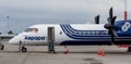 Passenger airplane Bombardier Q400 NextGen of Aurora company on service on airfield Royalty Free Stock Photo