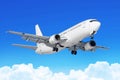 Passenger airplane with the chassis released before the landing at the airport against the blue sky cumulus clouds. Royalty Free Stock Photo