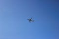 Passenger airplane in clean blue sky. Modern aircraft flying with tourists. Royalty Free Stock Photo