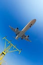 Passenger airplane flies above the airport approach landing lights Royalty Free Stock Photo