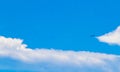 Passenger airplane flies in blue sky with clouds in Mexico