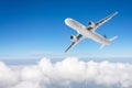 Passenger airplane flies in the deep blue sky over cloudscape Royalty Free Stock Photo