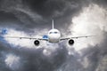 Passenger airplane flies through the turbulence zone through the lightning of storm clouds in bad weather. Royalty Free Stock Photo