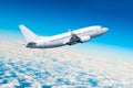 Passenger airplane fly on a hight above overcast clouds and blue sky. Royalty Free Stock Photo