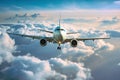 Passenger airplane flying above clouds. View from the window plane to amazing sky with beautiful clouds. Royalty Free Stock Photo