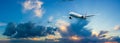 Passenger airplane flying above night clouds and amazing sky at the sunset.