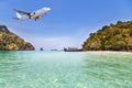 Passenger airplane flying above small island in tropical andaman sea Royalty Free Stock Photo