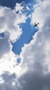 The passenger airplane is flying far away in the blue sky and clouds. Dramatic clouds with the sun shining through them. Aircraft Royalty Free Stock Photo