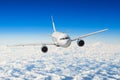 Passenger airplane flying at flight level high in the sky above the clouds. Royalty Free Stock Photo