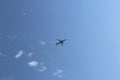 A passenger airplane flying high in the sky among the clouds. Air liner leaving a trace of exhaust gases glowing in the sun. Ecolo Royalty Free Stock Photo