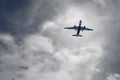 Passenger airplane flying on storm dark clouds background