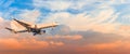Passenger airplane is landing approach gear released, against sunset sky clouds, panorama. Travel aviation, flight, trip Royalty Free Stock Photo