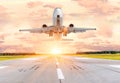 Passenger airplane landing and missed approach go around at sunset on a runway. Royalty Free Stock Photo