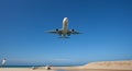 Passenger airplane landing over sea in summer season.