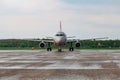 Passenger airplane is landing on rainy airport