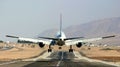 Passenger airplane landing on runway. Royalty Free Stock Photo