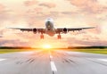 Passenger airplane landing at sunset on a runway. Royalty Free Stock Photo