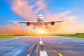 Passenger airplane landing at sunset on a runway. Royalty Free Stock Photo