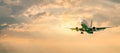 Passenger airplane. Landscape with Front of white airplane is flying in the orange sky with clouds, Passenger aircraft is landing Royalty Free Stock Photo