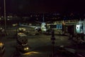 Passenger airplane on runway near the terminal in an airport at night time. Airport land crew doing flight service for passenger a Royalty Free Stock Photo