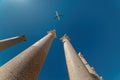 Passenger airplane seen looking up from under the marble column in the ancient city of Perge, Antalya