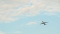 Passenger airplane takes off against the blue sky with clouds. Royalty Free Stock Photo