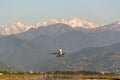 Passenger airplane taking off the runway. Mountains in the background. Royalty Free Stock Photo