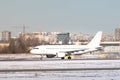 Passenger airplane taxing on runway for take off at daytime in winter day