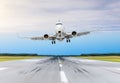Passenger airplane tilted from a strong wind landing on a runway airport. Royalty Free Stock Photo