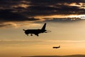 Passenger airplanes landing in the evening sun