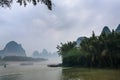 passenger boads in mist over river near Xingping