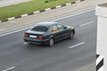 Passenger car black in the city rear view