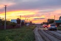 Passenger cars driving on rural road in village at sundown, Russia Royalty Free Stock Photo